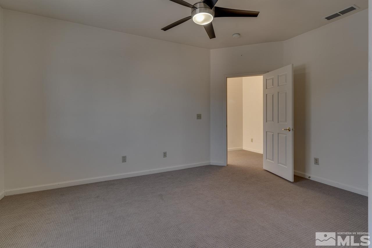 900 S Meadows, Unit 2623 Reno, NV 89521 - Photo 13 of 28 an empty room with a ceiling fan and a window