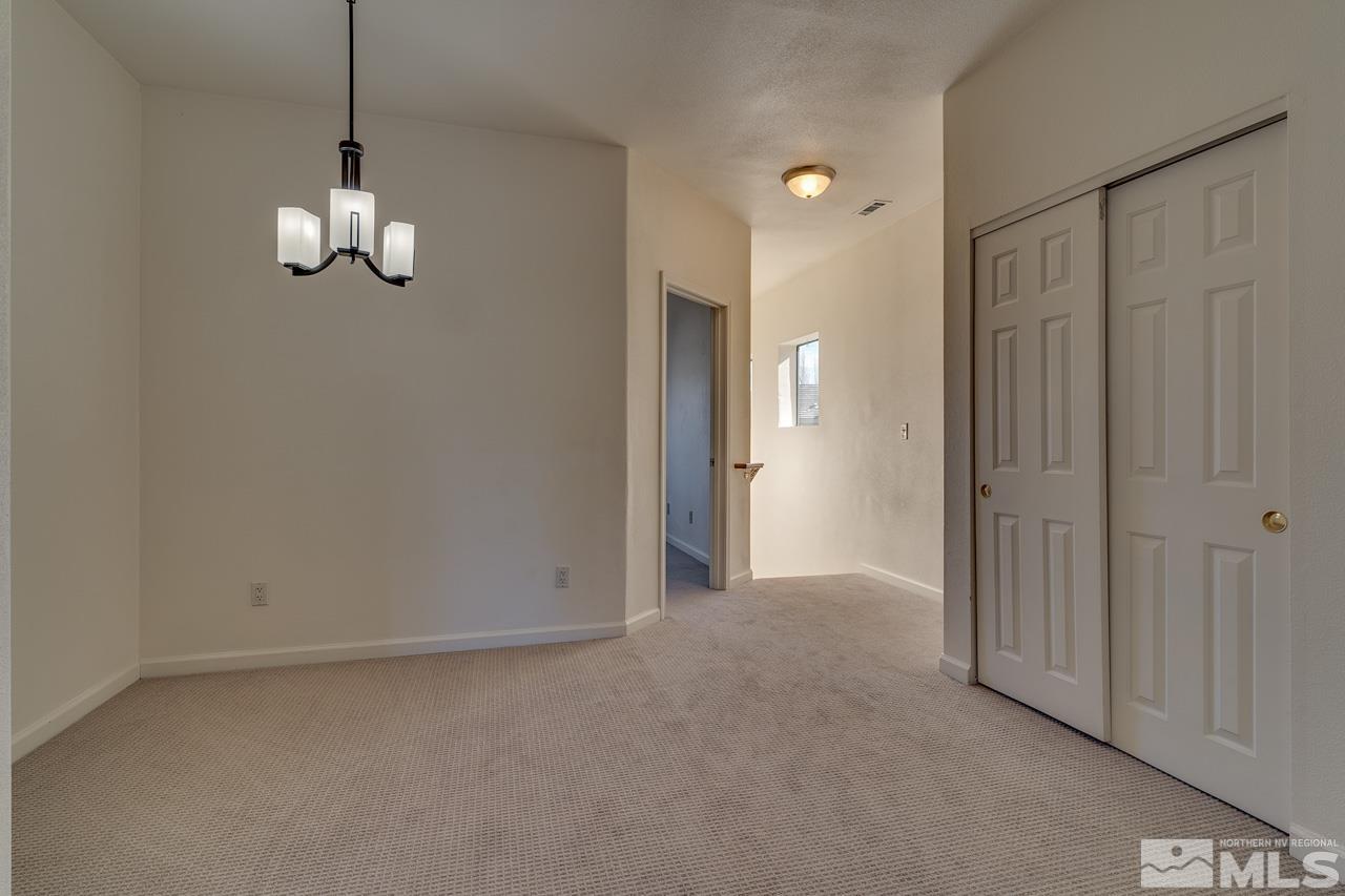 900 S Meadows, Unit 2623 Reno, NV 89521 - Photo 4 of 28 a view of empty room with wooden floor