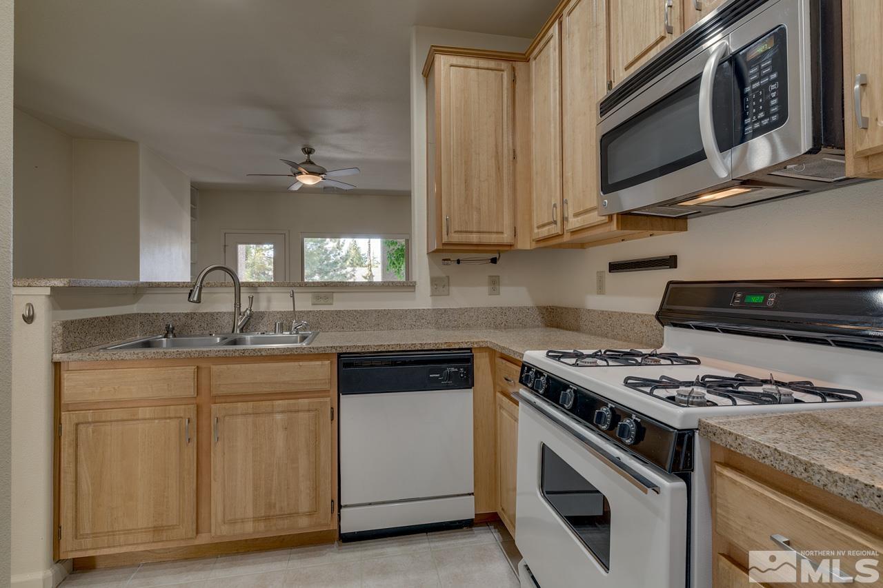 900 S Meadows, Unit 2623 Reno, NV 89521 - Photo 8 of 28 a kitchen with cabinets stainless steel appliances and sink