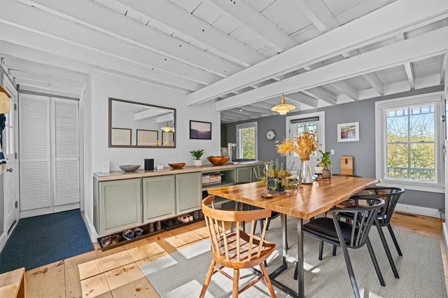 a view of a dining room with furniture and a potted plant