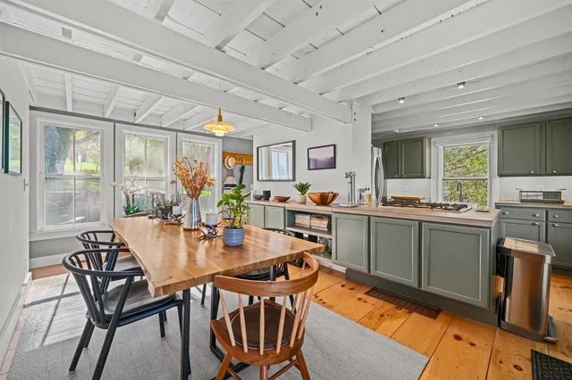 a kitchen with a stove a sink and a window