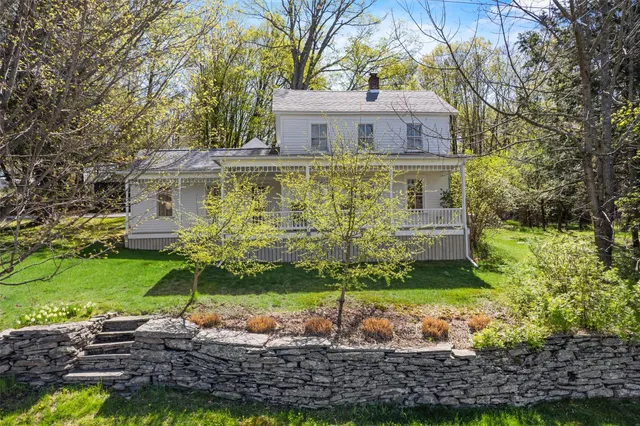 a front view of house with yard and green space