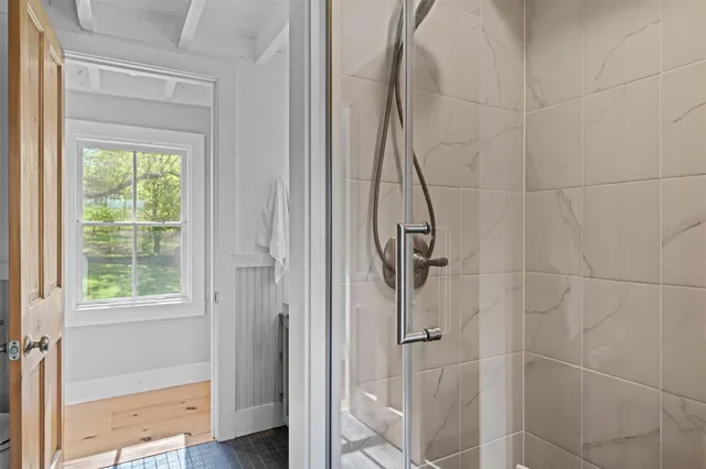 a view of a chair and table in backyard of the house