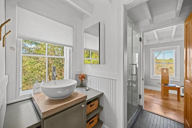 a bathroom with mirror and vanity