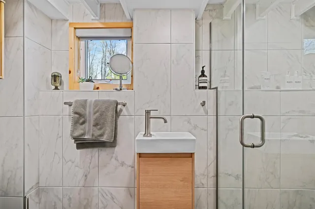 a bedroom with a bed a flat screen tv and dresser