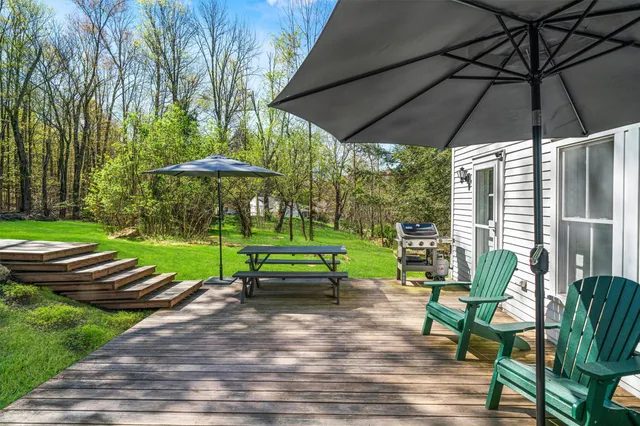 a front view of a house with patio and garden