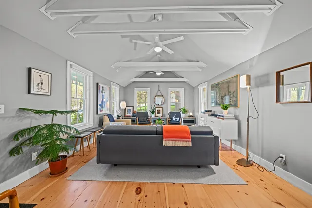 a living room with furniture a fireplace and a large window