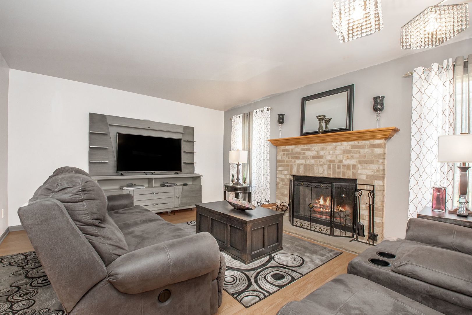 1925 Tilson Lane Romeoville, IL 60446 - Photo 11 of 27 a living room with furniture a flat screen tv and a fireplace