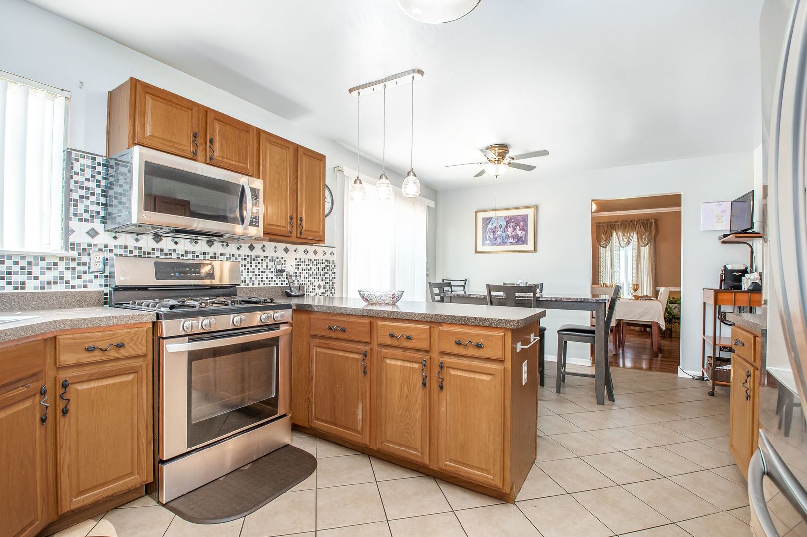 1925 Tilson Lane Romeoville, IL 60446 - Photo 13 of 27 a kitchen with cabinets and chairs