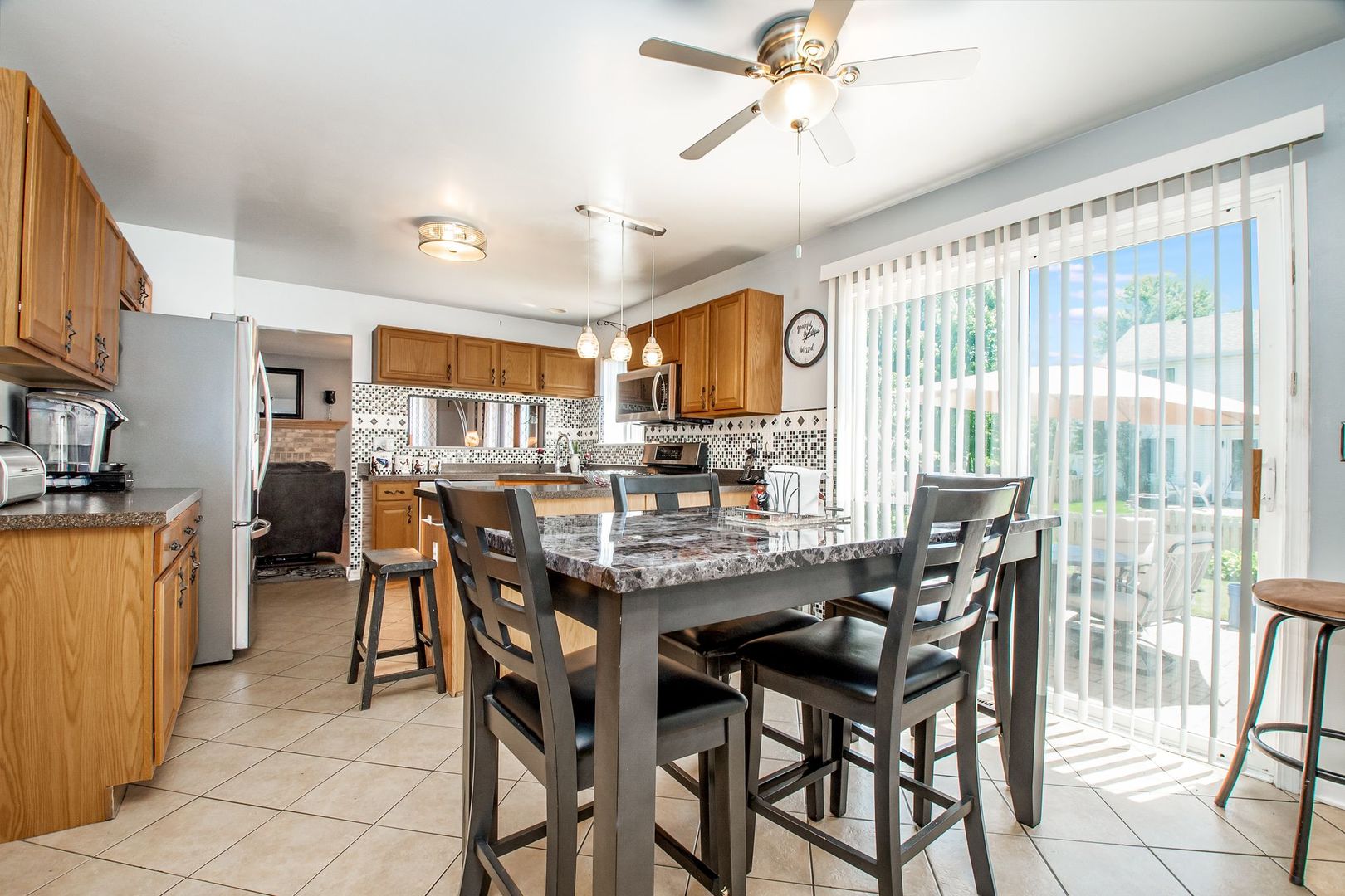 1925 Tilson Lane Romeoville, IL 60446 - Photo 15 of 27 a dining area with stainless steel appliances a table and chairs