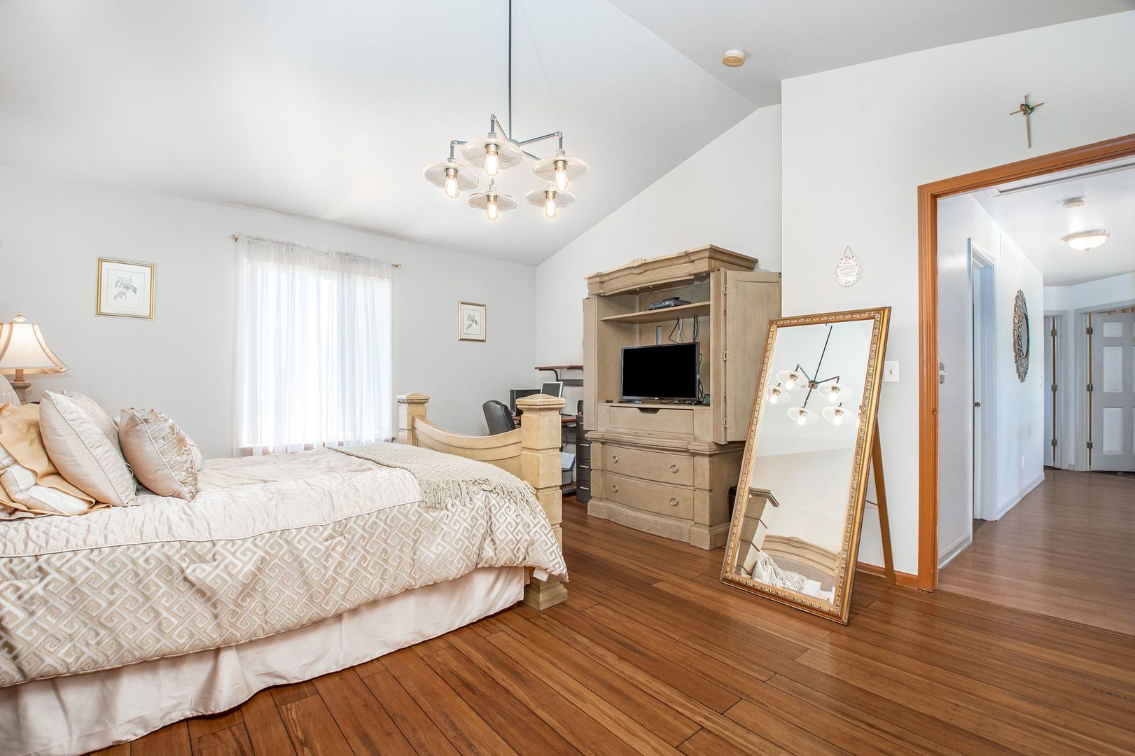1925 Tilson Lane Romeoville, IL 60446 - Photo 19 of 27 a bedroom with a large bed a flat tv screen and a dresser