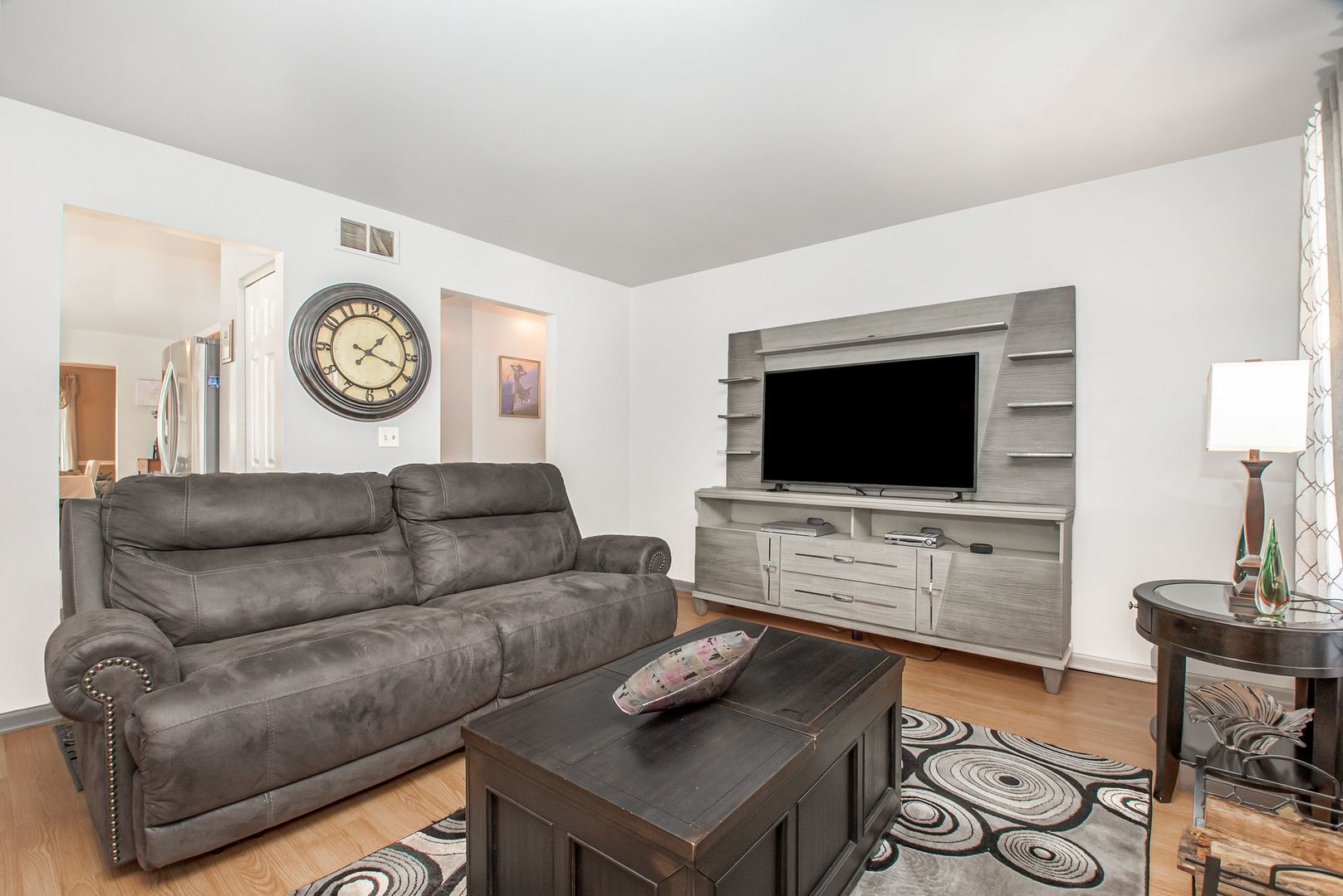 1925 Tilson Lane Romeoville, IL 60446 - Photo 10 of 27 a living room with furniture and a flat screen tv