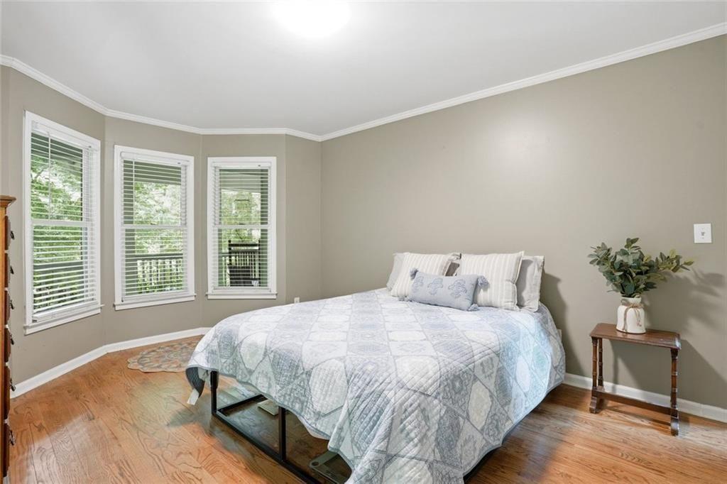 3259 Etchison Road Loganville, GA 30052 - Photo 18 of 50 a bedroom with a bed potted plant on table and a window
