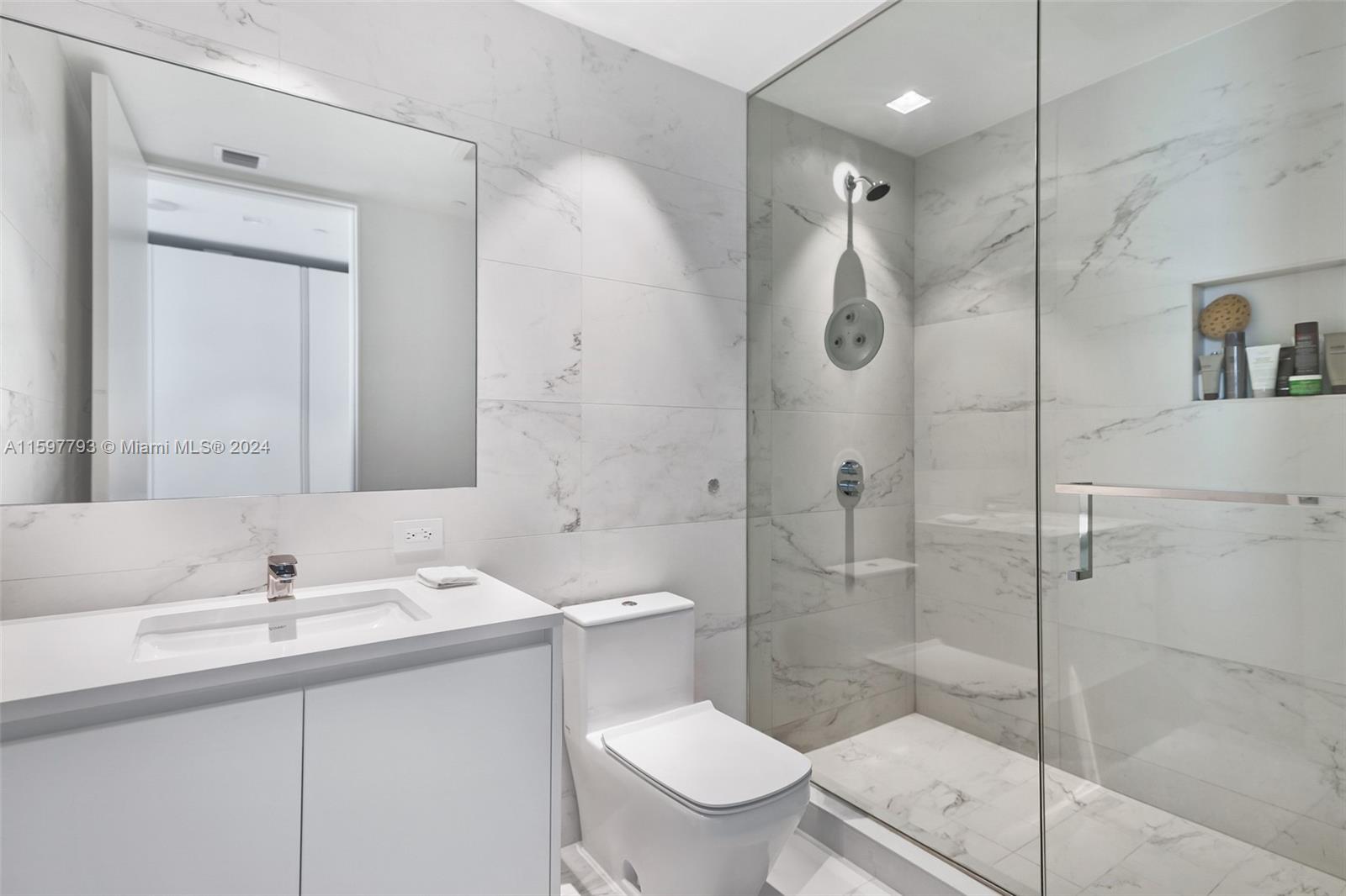 1000 Biscayne Boulevard, Unit 3701 Miami, FL 33132 - Photo 31 of 98 a bathroom with a sink a toilet and shower