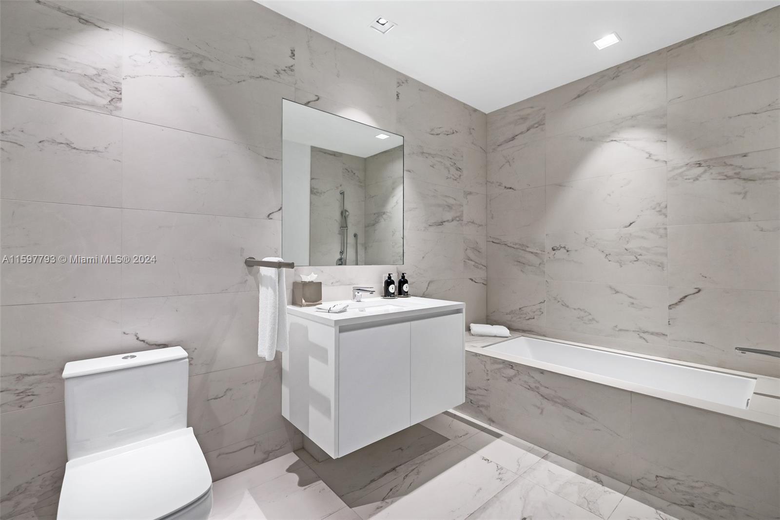 1000 Biscayne Boulevard, Unit 3701 Miami, FL 33132 - Photo 34 of 98 a bathroom with a sink a toilet and shower