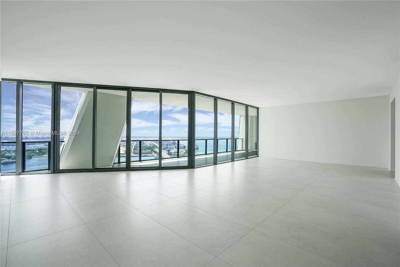 1000 Biscayne Boulevard, Unit 3701 Miami, FL 33132 - Photo 43 of 98 a view of an empty room with wooden floor and a window