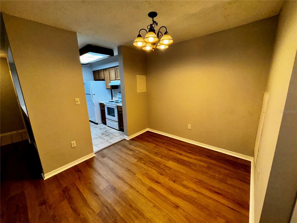 180 Waterfall Way, Unit 203 Altamonte Springs, FL 32714 - Photo 13 of 26 wooden floor in an empty room with a window
