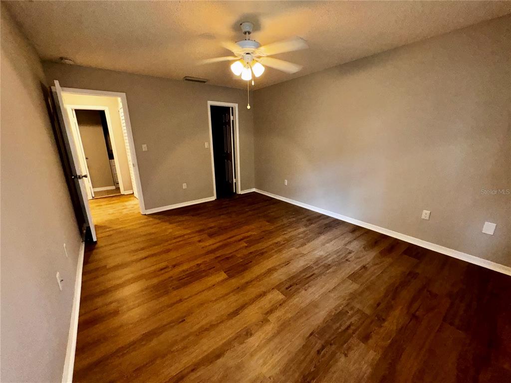 180 Waterfall Way, Unit 203 Altamonte Springs, FL 32714 - Photo 16 of 26 wooden floor in an empty room with a window