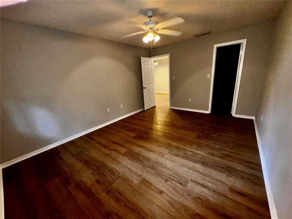 180 Waterfall Way, Unit 203 Altamonte Springs, FL 32714 - Photo 17 of 26 a view of an empty room with window and wooden floor