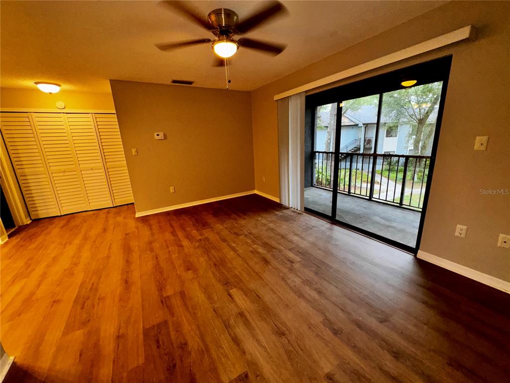 180 Waterfall Way, Unit 203 Altamonte Springs, FL 32714 - Photo 2 of 26 wooden floor in an empty room with a window