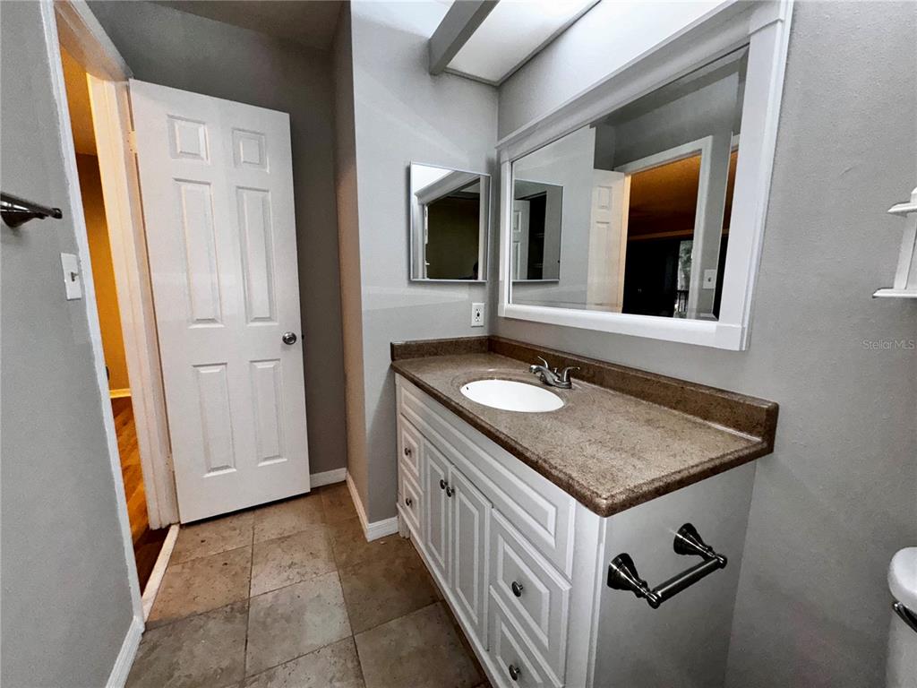 180 Waterfall Way, Unit 203 Altamonte Springs, FL 32714 - Photo 22 of 26 a bathroom with a sink and a mirror