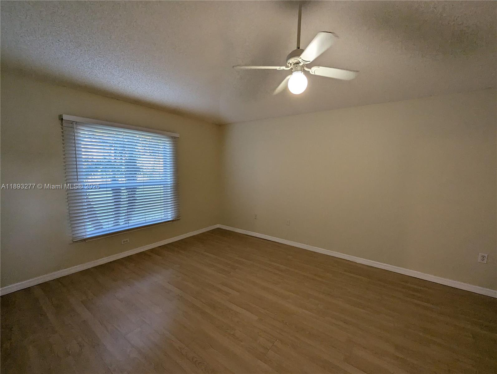 78 Pine Grove Drive Palm Coast, FL 32164 - Photo 12 of 49 an empty room with wooden floor and windows