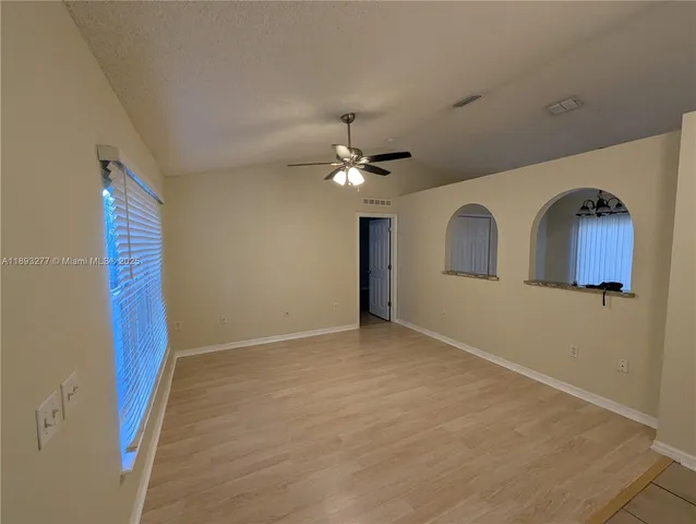 a kitchen with stainless steel appliances granite countertop a refrigerator and a stove