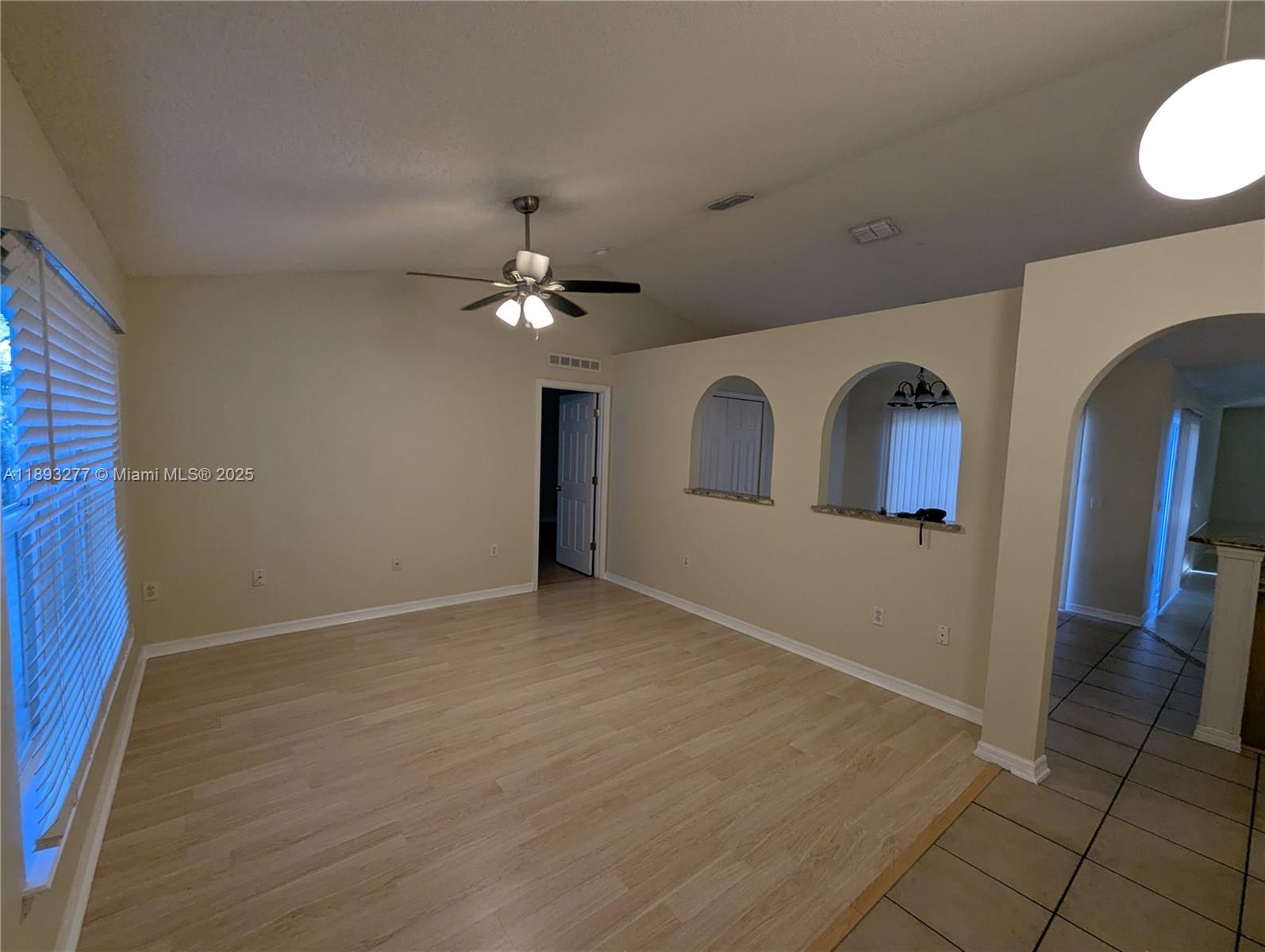 78 Pine Grove Drive Palm Coast, FL 32164 - Photo 16 of 49 a view of livingroom with hardwood floor and kitchen view