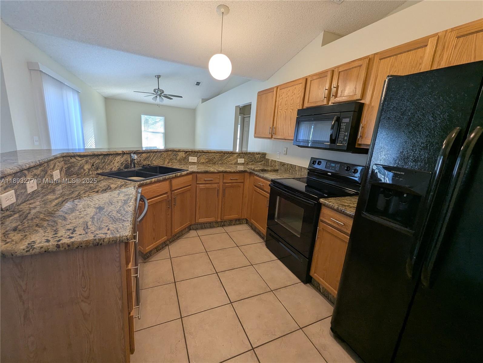 78 Pine Grove Drive Palm Coast, FL 32164 - Photo 18 of 49 a kitchen with stainless steel appliances granite countertop a sink stove and refrigerator