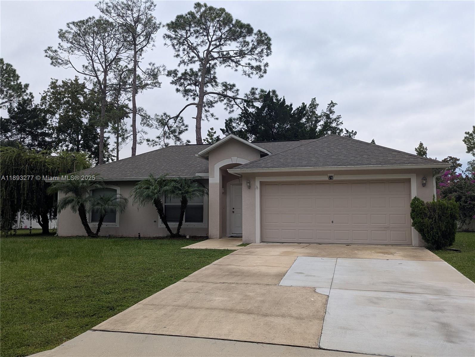 78 Pine Grove Drive Palm Coast, FL 32164 - Photo 2 of 49 front view of a house with a yard
