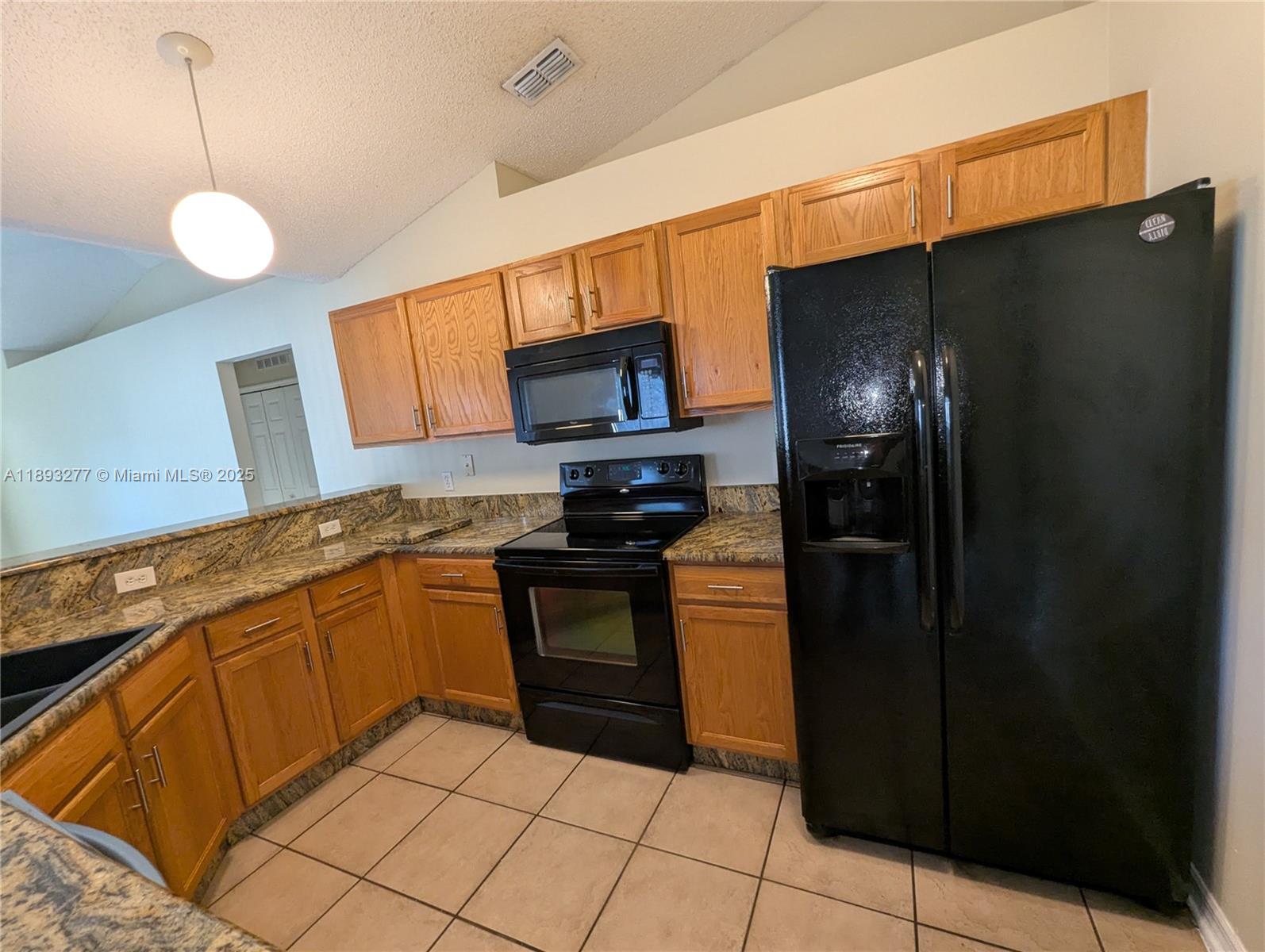 78 Pine Grove Drive Palm Coast, FL 32164 - Photo 21 of 49 a kitchen with stainless steel appliances granite countertop a refrigerator and a sink