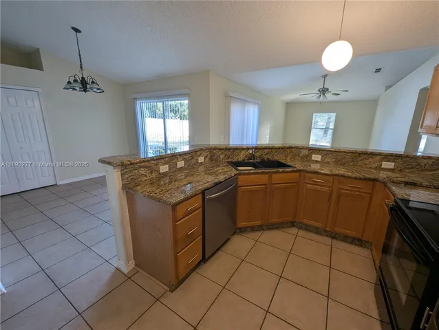 a bathroom with a granite countertop toilet a sink and a mirror