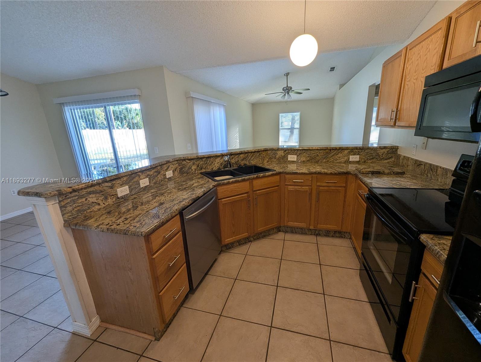 78 Pine Grove Drive Palm Coast, FL 32164 - Photo 25 of 49 a kitchen with stainless steel appliances granite countertop a sink stove and cabinets
