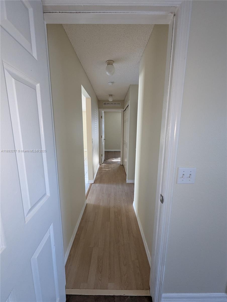 78 Pine Grove Drive Palm Coast, FL 32164 - Photo 38 of 49 a view of a hallway with wooden floor