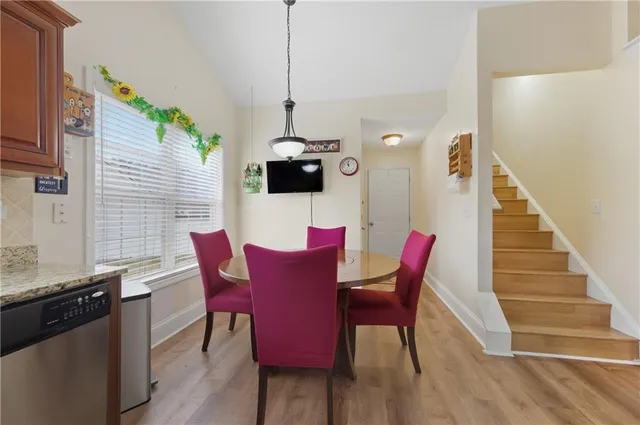 a view of a dining room with furniture wooden floor and chandelier