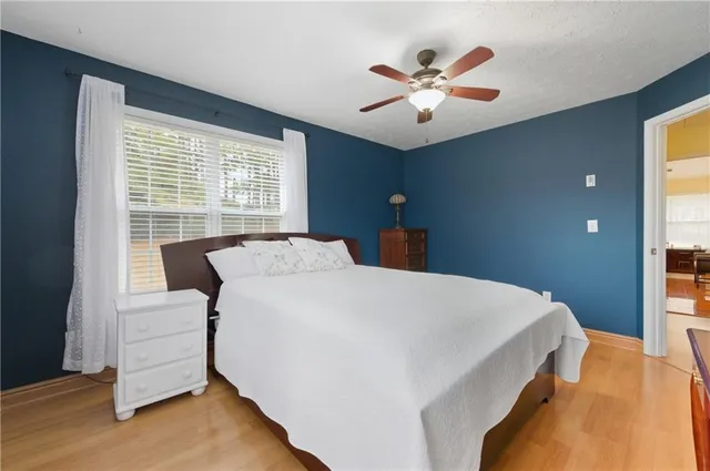 a bed sitting in a bedroom next to a window