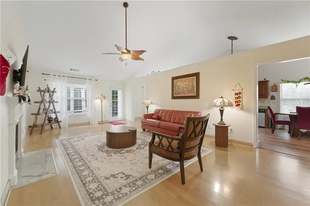 a living room with furniture a dining table and a chandelier