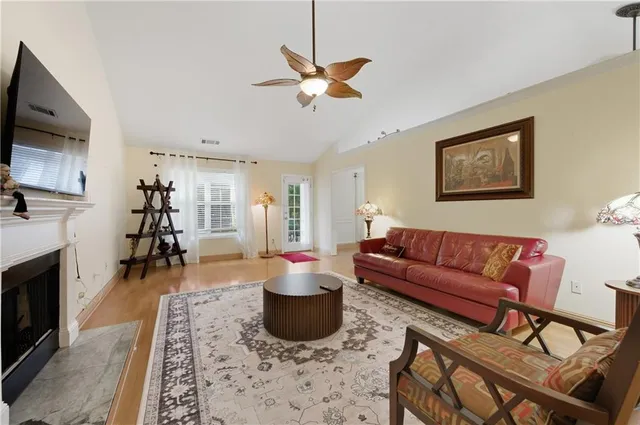 a living room with furniture ceiling fan and a rug