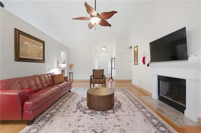 a living room with furniture a fireplace and a flat screen tv