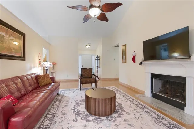 a living room with furniture a flat screen tv and a fireplace