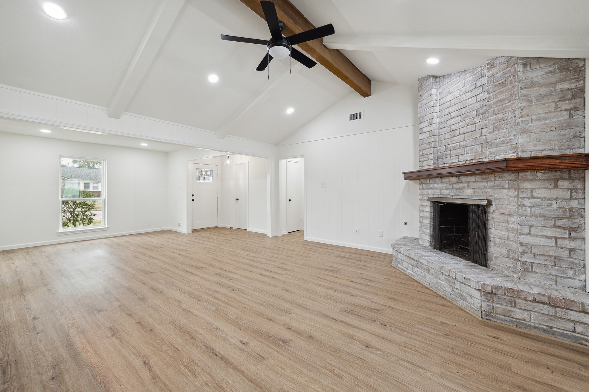 9719 Springmont Drive Houston, TX 77080 - Photo 10 of 32 A hallway leads to the bedrooms and door next to front door leads to a convenient guest powder room! The living space feels so SPACIOUS!