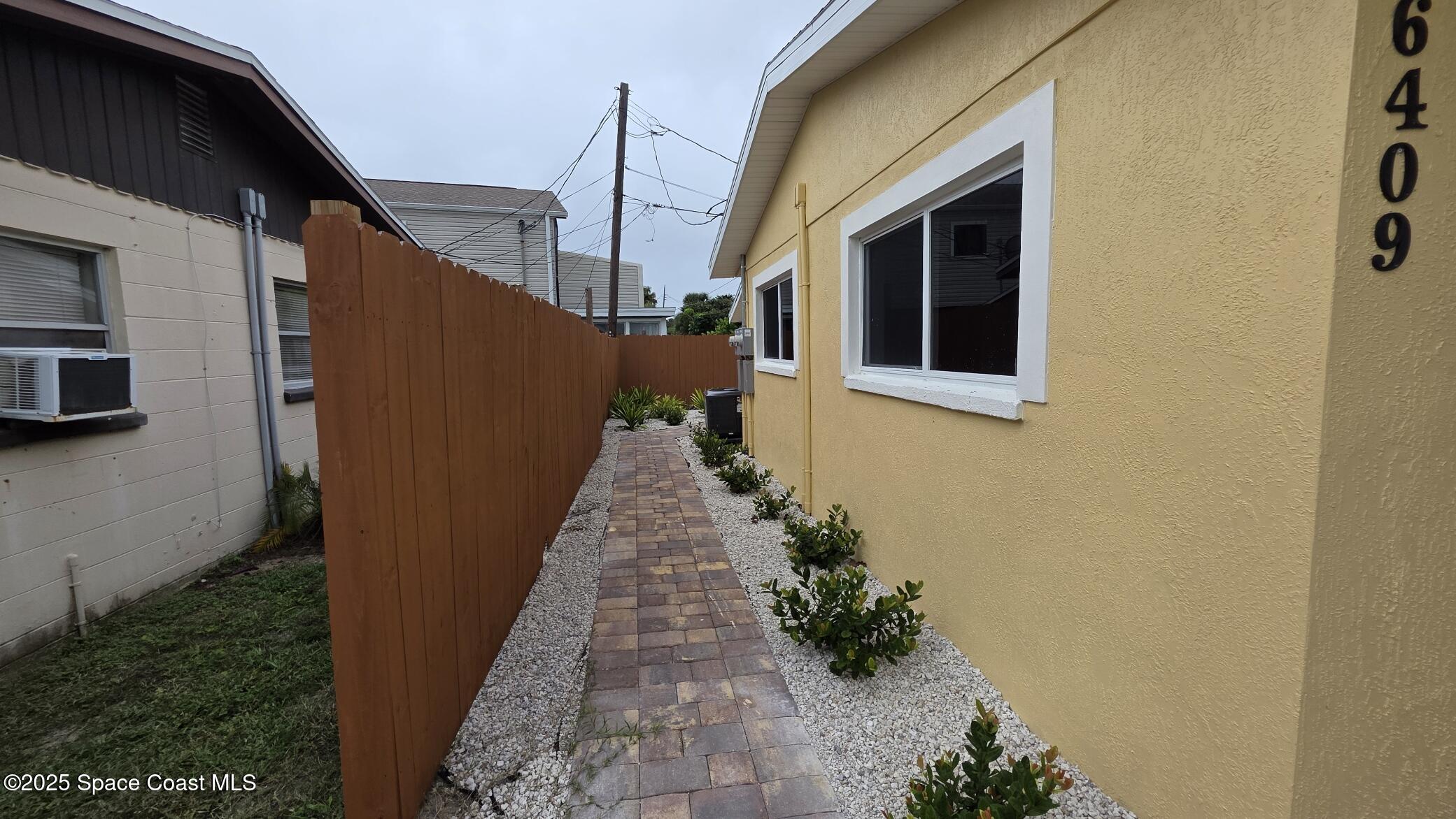 6409 Ridgewood Avenue Cocoa Beach, FL 32931 - Photo 13 of 17 a pathway of a house with a yard