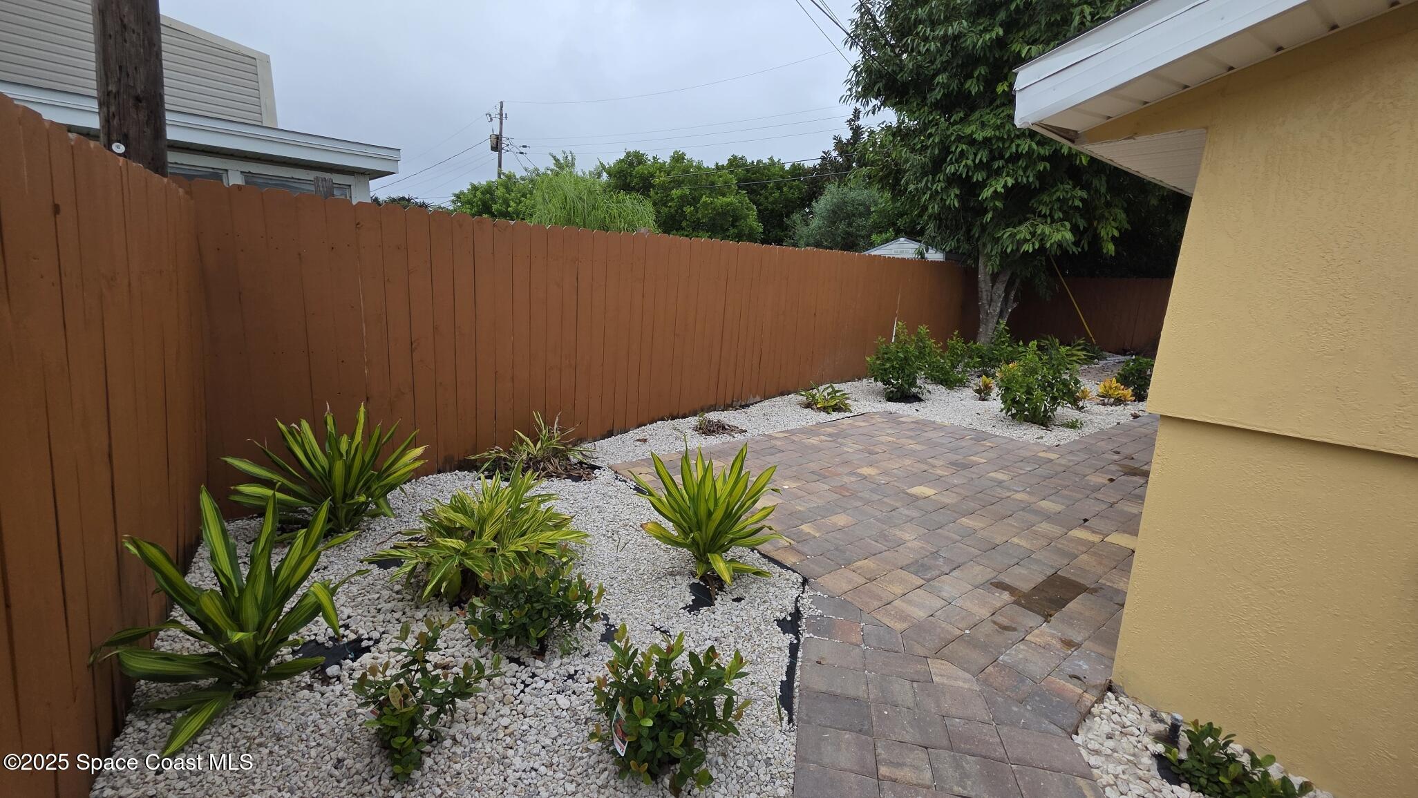 6409 Ridgewood Avenue Cocoa Beach, FL 32931 - Photo 14 of 17 a view of a house with a yard