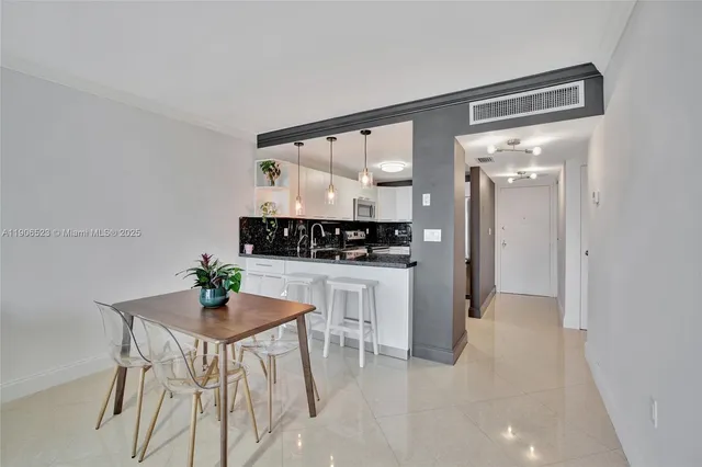 a view of kitchen and dining area with cabinets