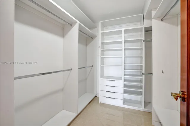 a view of walk in closet with empty racks