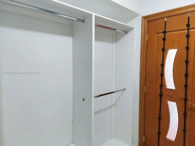 a bathroom with a shower and a glass door