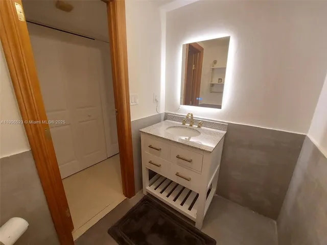 a bathroom with a sink a mirror and a toilet