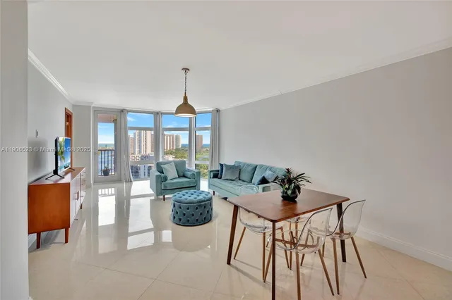 a living room with furniture and a chandelier