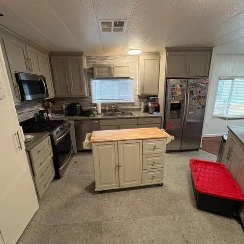 a kitchen with a sink stove and refrigerator