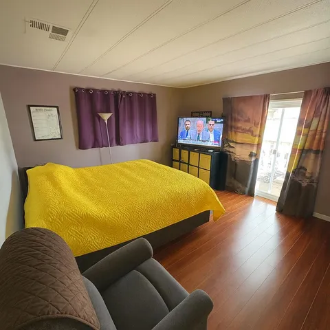 a bed room with a bed and a television